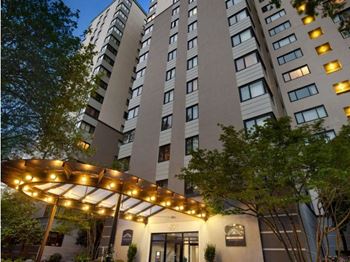 A tall building with a canopy in front of it at Skye at Belltown Apartments, Washington